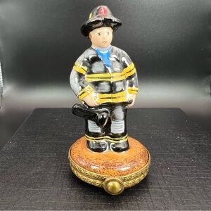 Firefighter Figurine with Black and Yellow Uniform.   Genuine Limoges hand done